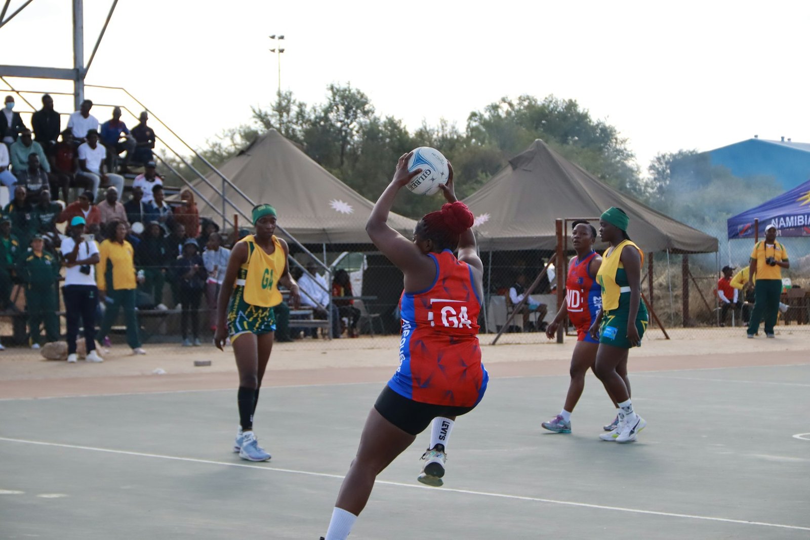 Netball player preparing to pass during a competitive match